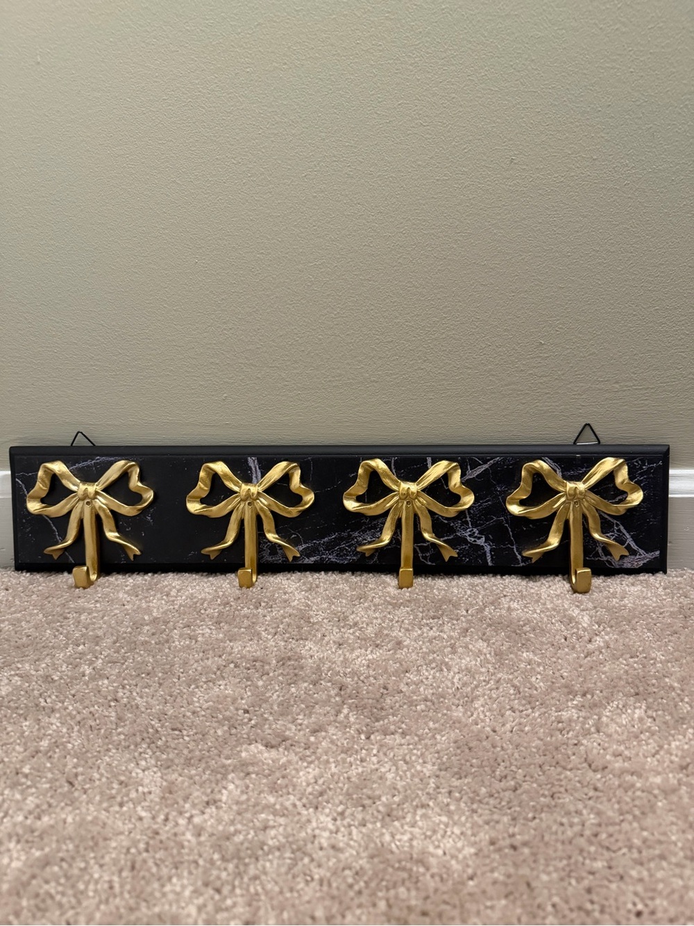 Black Faux Marble Wall Hook Rack with Gold Bow Hooks